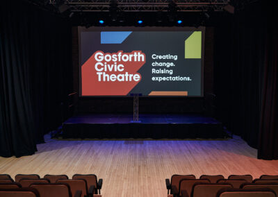Image of the main theatre at Gosforth Civic Theatre set up as a cinema with screen and raked seating